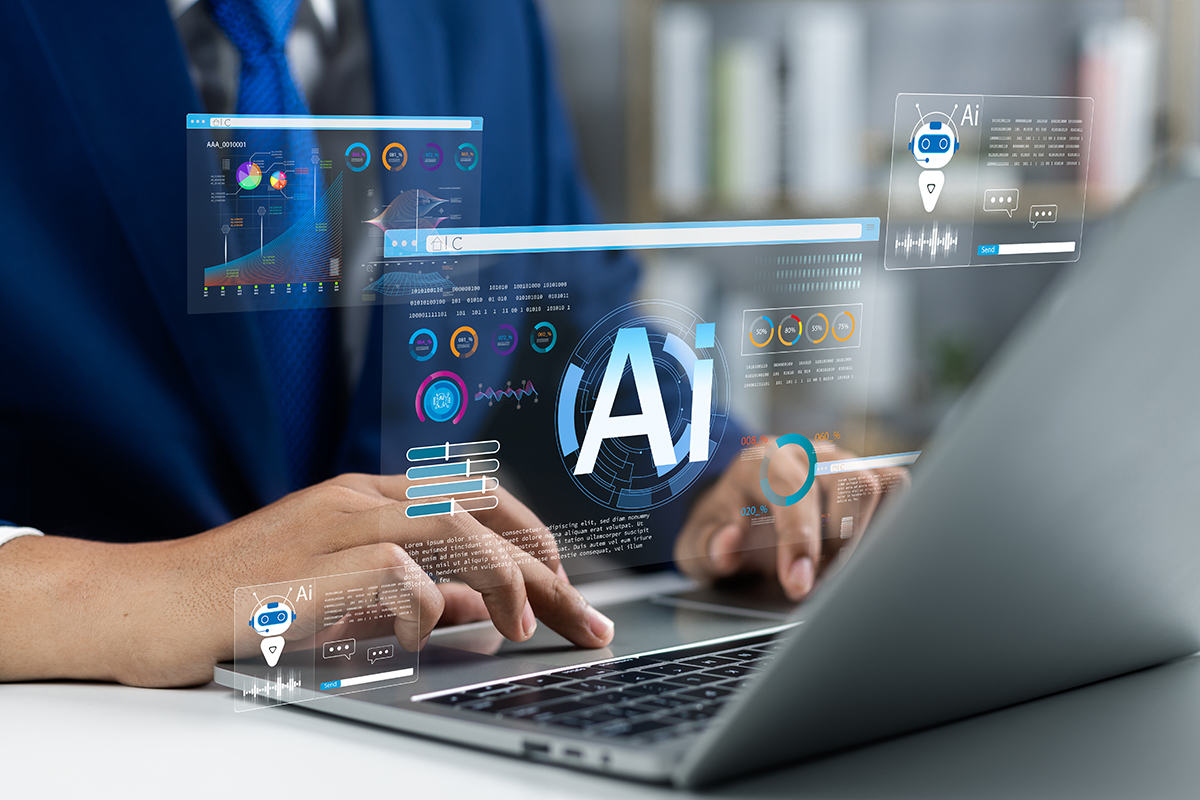 Holographic AI dashboards and charts hover above a laptop, with a large 'AI' in the center as a person types.